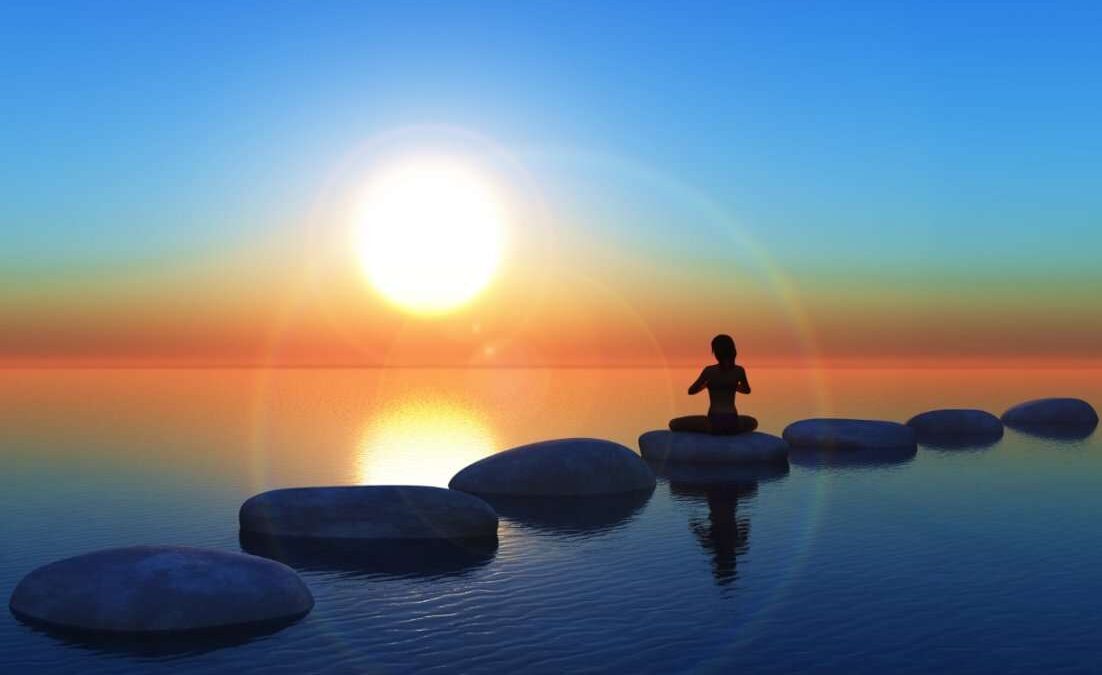 A person practicing meditation near a serene water body, embracing tranquility and inner peace